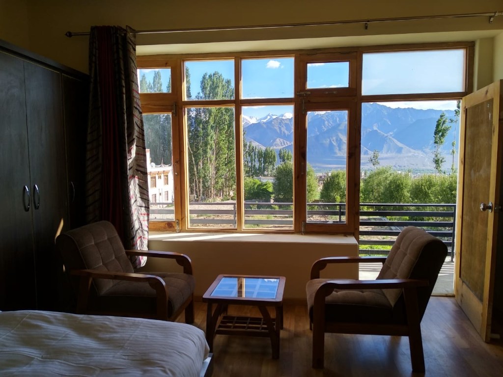View inside the guestroom and onsite garden at Orion Home guesthouse in Leh, Ladakh, India.